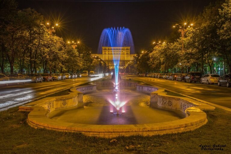 a fountain with blue lights in a park